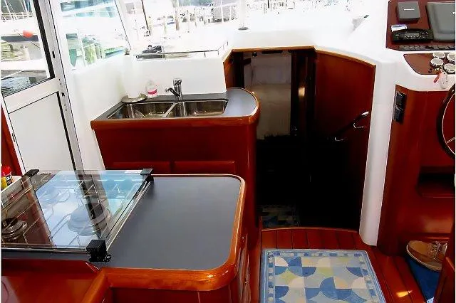 Slide: The Image of 2006 Beneteau Swift Trawler 42 interior with kitchen, sink, and stairs. - 34