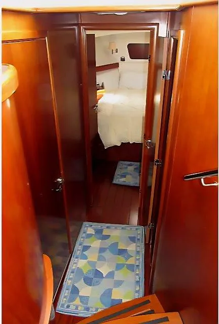 Slide: The Image of Interior view of 2006 Beneteau Swift Trawler 42, featuring wooden finishes and cozy cabin. - 37