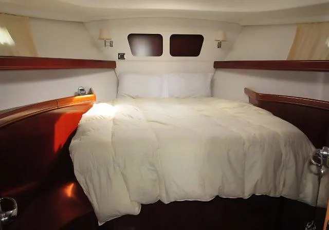 Slide: The Image of Luxurious cabin interior of 2006 Beneteau Swift Trawler 42 with cozy bedding. - 38