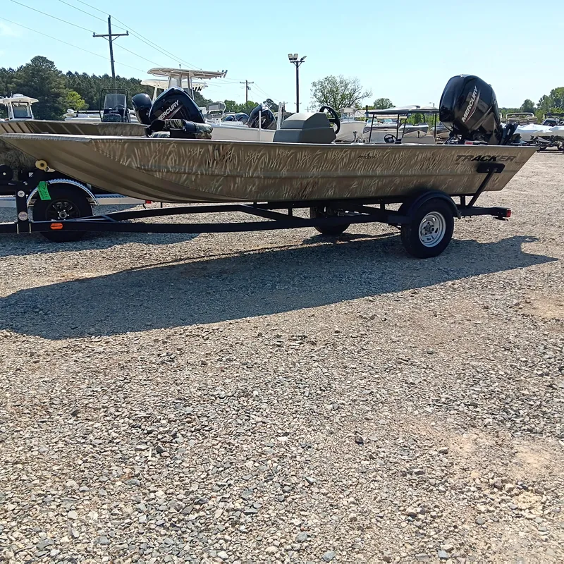 Slide: The Image of 2025 Tracker Grizzly 1754 SC boat on trailer in outdoor lot. - 2