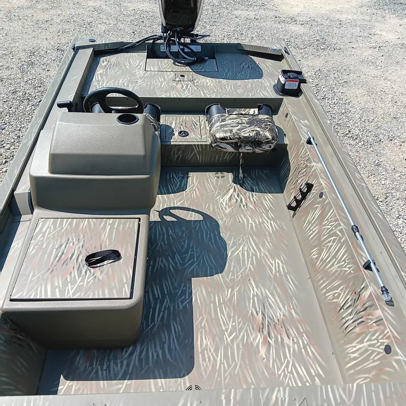 Slide: The Image of 2025 Tracker Grizzly 1754 SC boat interior with camouflage pattern and steering console. - 7