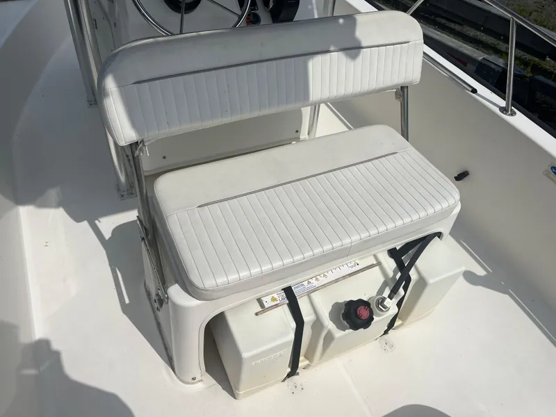 Slide: The Image of 2008 Boston Whaler 170 Montauk boat interior with white seating and fuel tank. - 13