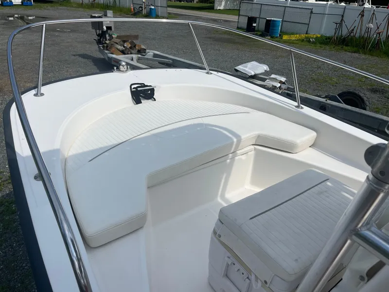 Slide: The Image of 2008 Boston Whaler 170 Montauk boat interior with white seating and cooler on trailer. - 4