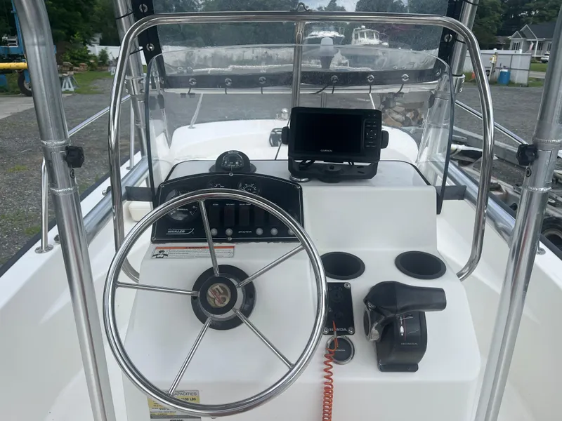 Slide: The Image of 2008 Boston Whaler 170 Montauk boat console with steering wheel and navigation equipment. - 6