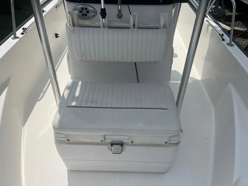 Slide: The Image of 2008 Boston Whaler 170 Montauk interior with white seating and storage. - 9