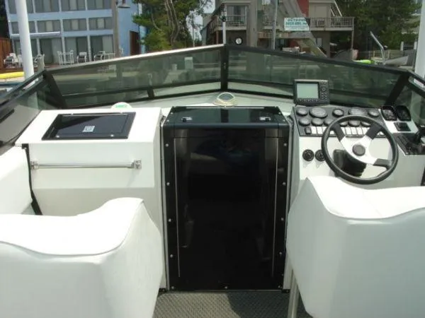 Slide: The Image of 1998 Corsa offshore flat deck boat cockpit with steering wheel and control panel. - 4