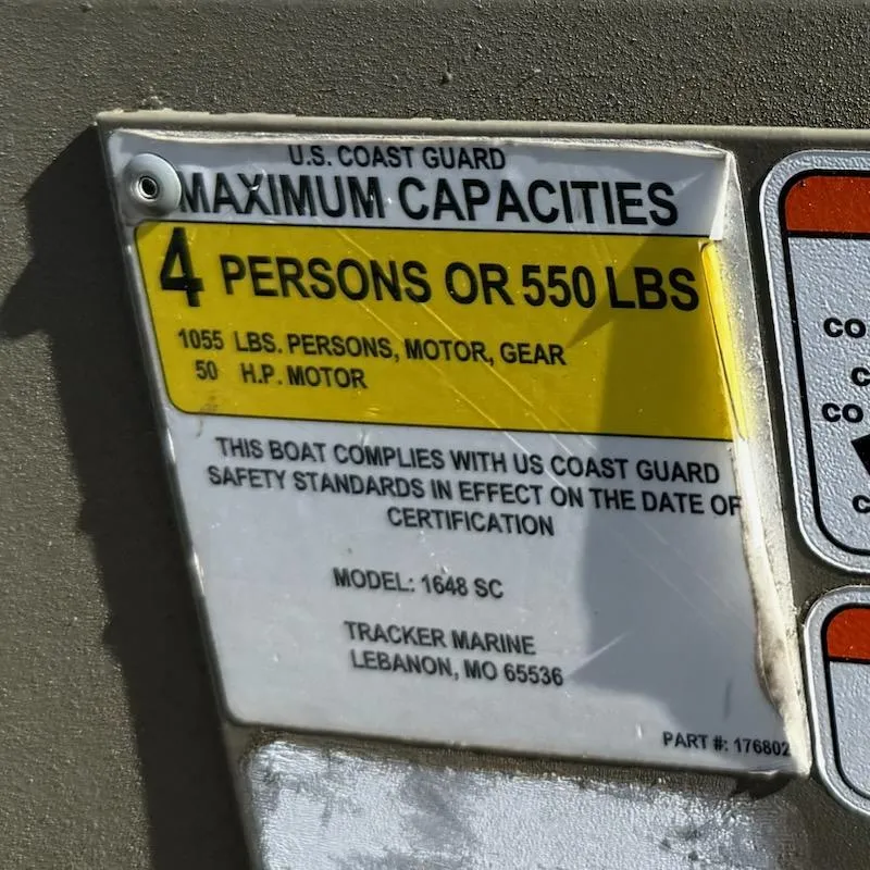 Slide: The Image of 2019 Tracker Grizzly Tracker 1648 MVX capacity label, 4 persons or 550 lbs, US Coast Guard compliant. - 10