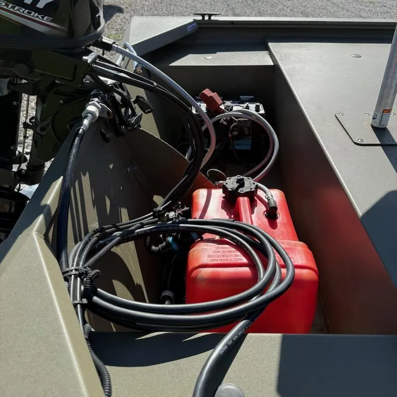 Slide: The Image of 2019 Tracker Grizzly Tracker 1648 MVX boat interior with red fuel tank and cables. - 5