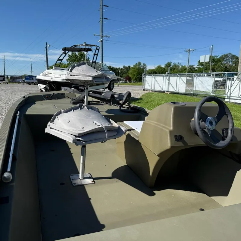 Slide: The Image of 2019 Tracker Grizzly Tracker 1648 MVX boat interior with steering wheel and seating. - 9