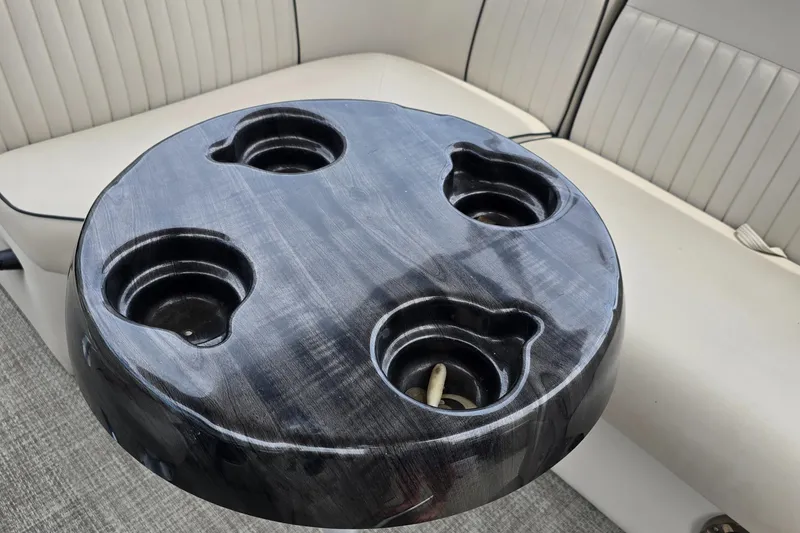 Slide: The Image of Round black table with cup holders on a 2019 Qwest LS 818 RLS boat. - 8