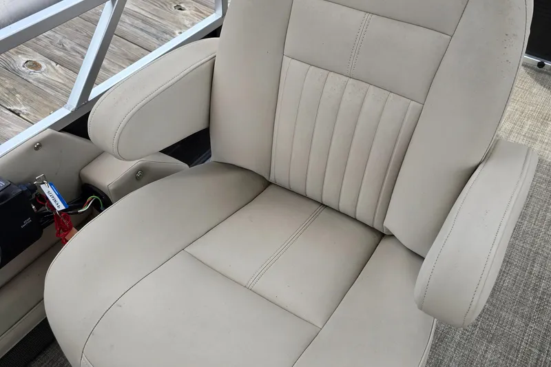 Slide: The Image of Beige captain's chair on 2019 Qwest LS 818 RLS boat, featuring armrests and stitching. - 9
