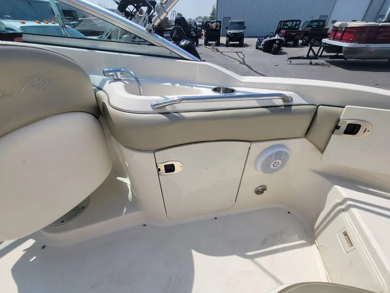 Slide: The Image of 2006 Sea Ray 220 Sundeck interior with sink and storage compartments. - 18