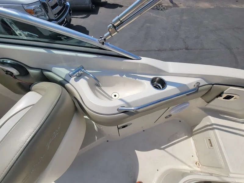 Slide: The Image of Interior of a 2006 Sea Ray 220 Sundeck boat, featuring a sink and seating area. - 19
