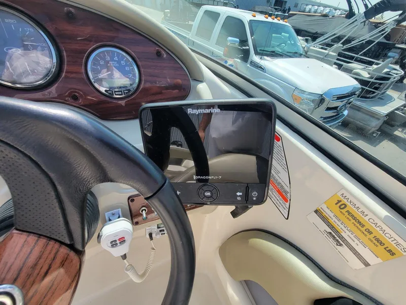 Slide: The Image of 2006 Sea Ray 220 Sundeck dashboard with Raymarine Dragonfly-7 display and steering wheel. - 21