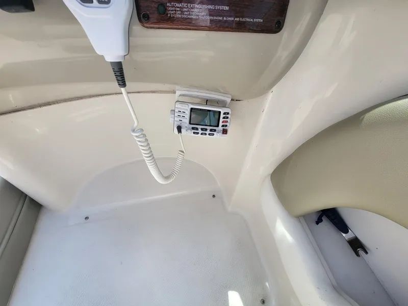 Slide: The Image of 2006 Sea Ray 220 Sundeck interior with radio and microphone setup. - 22