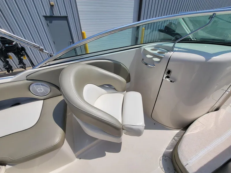 Slide: The Image of 2006 Sea Ray 220 Sundeck interior with seating and dashboard details. - 23