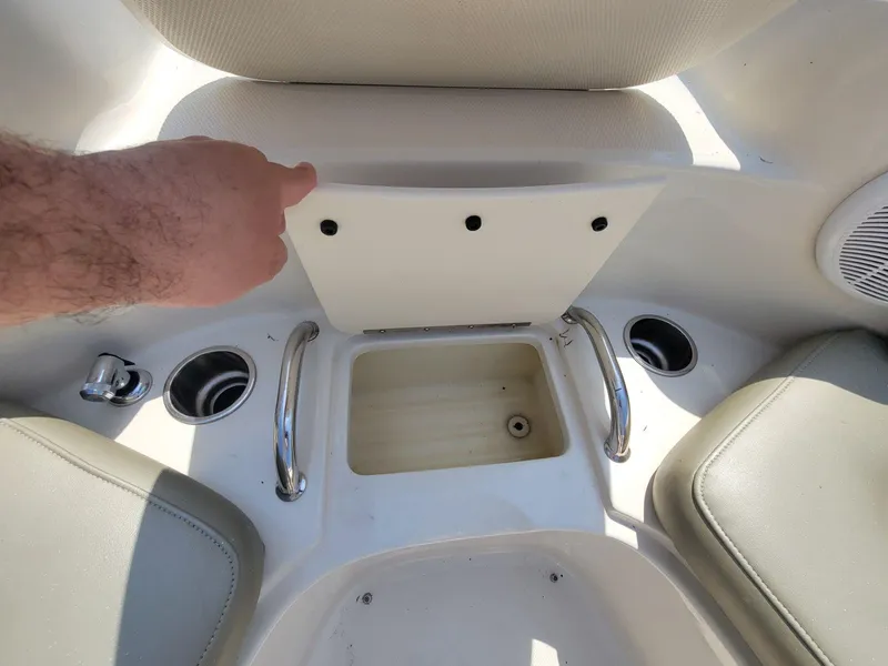 Slide: The Image of Interior of a 2006 Sea Ray 220 Sundeck boat showing seating and storage compartment. - 26