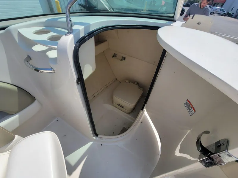 Slide: The Image of 2006 Sea Ray 220 Sundeck interior with compact marine toilet. - 31