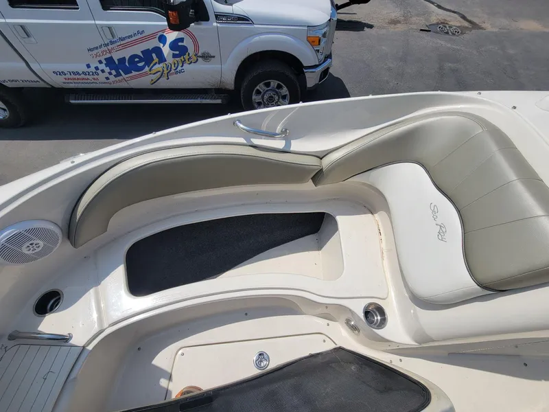 Slide: The Image of 2006 Sea Ray 220 Sundeck interior with cushioned seating and speaker detail. - 34