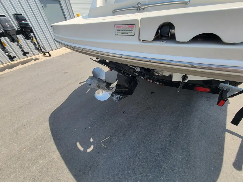 Slide: The Image of Rear view of a 2006 Sea Ray 220 Sundeck boat with visible propeller and trailer. - 5