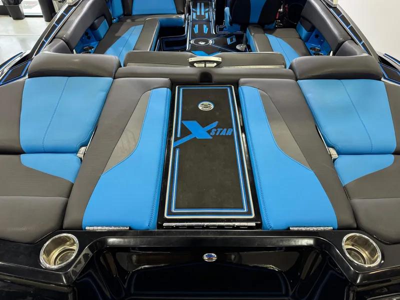 Slide: The Image of 2018 MasterCraft XStar interior with blue and gray seating, showcasing luxury and style. - 10