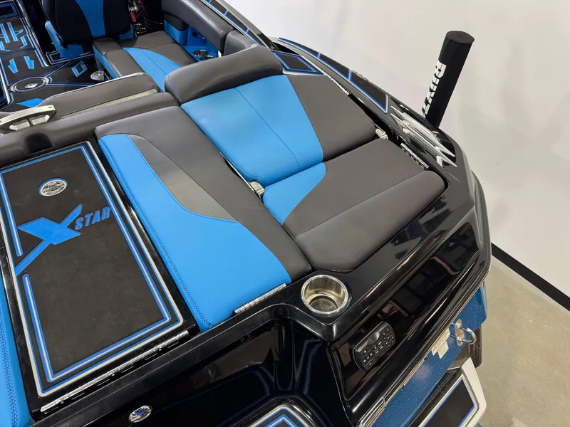 Slide: The Image of 2018 MasterCraft XStar boat interior with blue and black seating and custom detailing. - 11