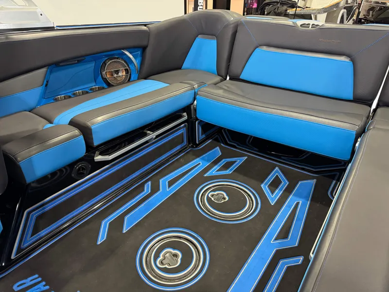 Slide: The Image of 2018 MasterCraft XStar interior with blue and black seating and custom flooring design. - 15