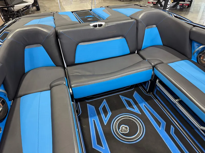 Slide: The Image of 2018 MasterCraft XStar interior with blue and gray seating, showcasing modern design and comfort. - 16