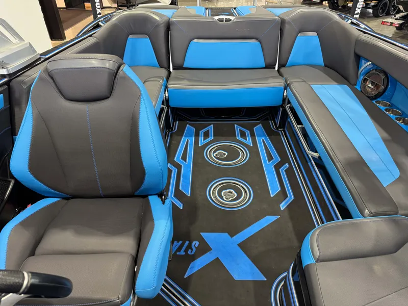 Slide: The Image of 2018 MasterCraft XStar interior with blue and black seating and custom flooring design. - 25