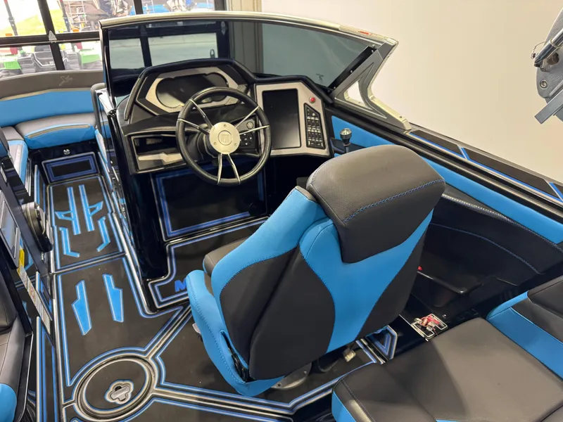 Slide: The Image of 2018 MasterCraft XStar interior with blue and black seating and modern dashboard design. - 27