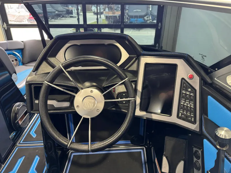 Slide: The Image of 2018 MasterCraft XStar dashboard with steering wheel and digital controls. - 29