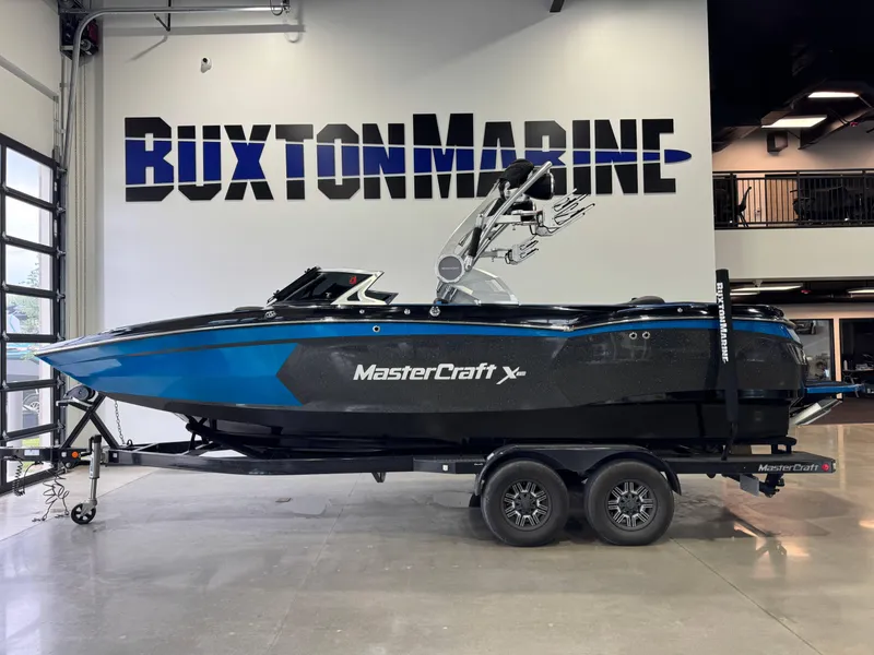 Slide: The Image of 2018 MasterCraft XStar boat on trailer at Buxton Marine showroom. - 4