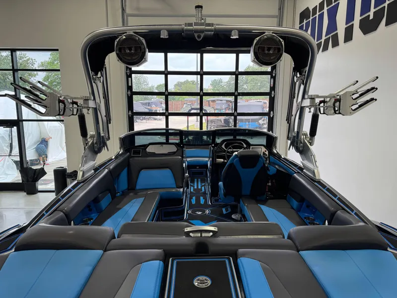 Slide: The Image of Interior of a 2018 MasterCraft XStar boat with blue and black seating. - 9