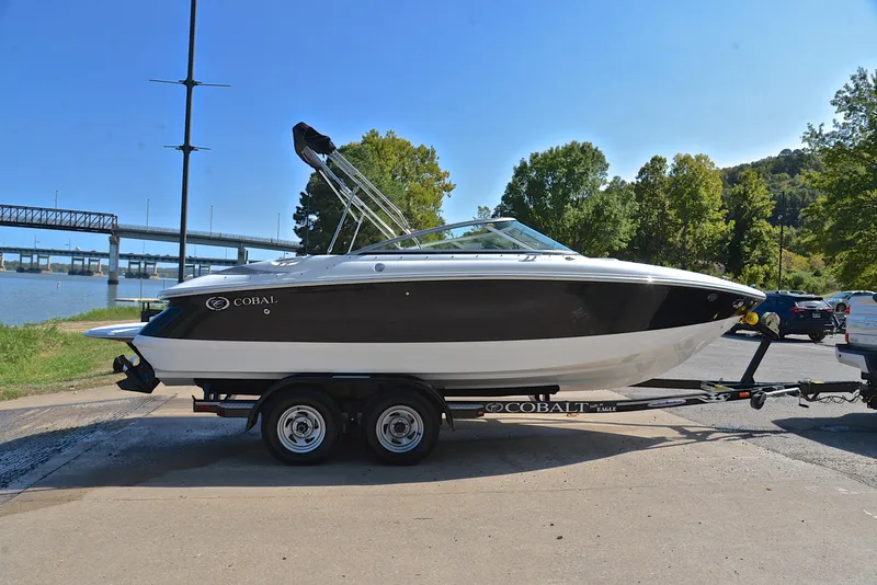 Slide: The Image of 2007 Cobalt 200 boat on trailer by river, sunny day, trees in background. - 15