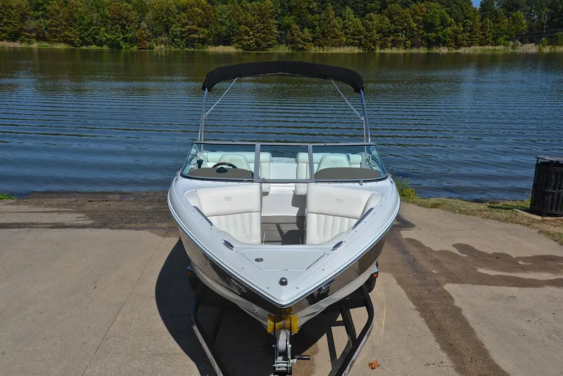 Slide: The Image of 2007 Cobalt 200 boat on trailer by a serene lake. - 17