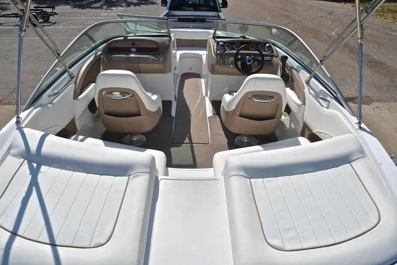 Slide: The Image of 2007 Cobalt 200 boat interior with white seating and dual consoles. - 18