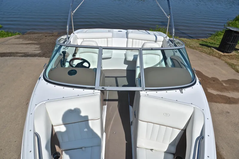 Slide: The Image of 2007 Cobalt 200 boat with white interior, docked by a calm lake. - 20