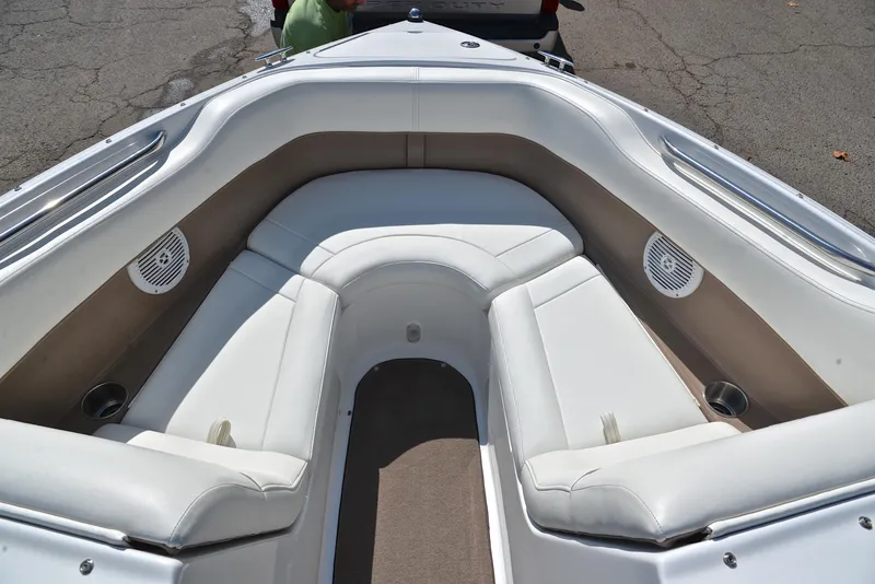 Slide: The Image of 2007 Cobalt 200 boat interior with white seating and built-in speakers. - 21