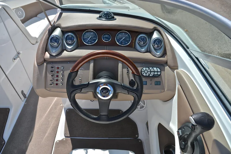Slide: The Image of 2007 Cobalt 200 boat dashboard with gauges, steering wheel, and control panel. - 26
