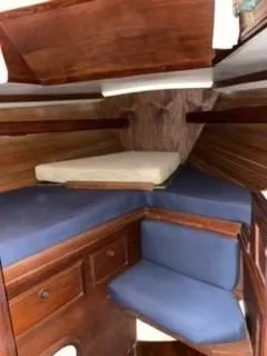 Slide: The Image of Interior cabin of 1981 Cape Dory 33 Sloop with blue cushions and wooden finish. - 15