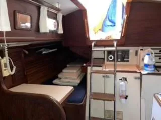 Slide: The Image of Interior of 1981 Cape Dory 33 Sloop, featuring cozy cabin with wooden finishes and ladder access. - 18