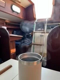 Slide: The Image of Interior of 1981 Cape Dory 33 Sloop with a steaming cup on the table. - 19