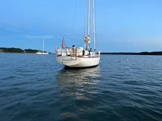 Slide: The Image of 1981 Cape Dory 33 Sloop sailboat on calm water under a clear blue sky. - 2