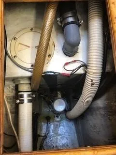 Slide: The Image of 1981 Cape Dory 33 Sloop engine compartment with hoses and wiring. - 25