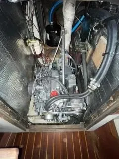 Slide: The Image of Engine compartment of a 1981 Cape Dory 33 Sloop, showing mechanical components and wiring. - 30