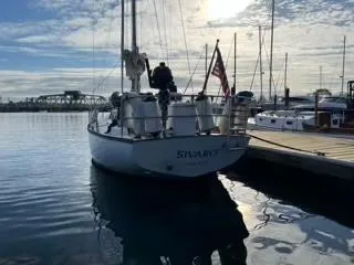 Slide: The Image of 1981 Cape Dory 33 Sloop docked at marina under a cloudy sky. - 4