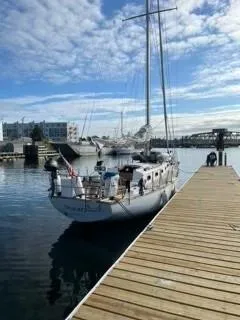 Slide: The Image of 1981 Cape Dory 33 Sloop docked at a marina under a partly cloudy sky. - 6