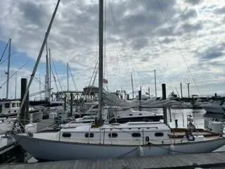 Slide: The Image of 1981 Cape Dory 33 Sloop docked at marina under cloudy sky. - 7