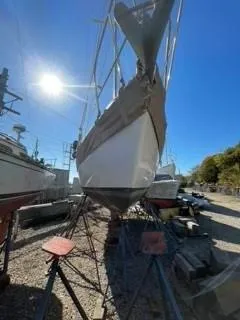 Slide: The Image of 1981 Cape Dory 33 Sloop sailboat on stands under bright blue sky. - 8