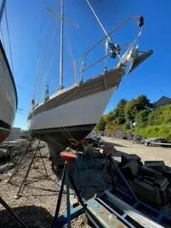 Slide: The Image of 1981 Cape Dory 33 Sloop sailboat on dry dock under clear blue sky. - 9